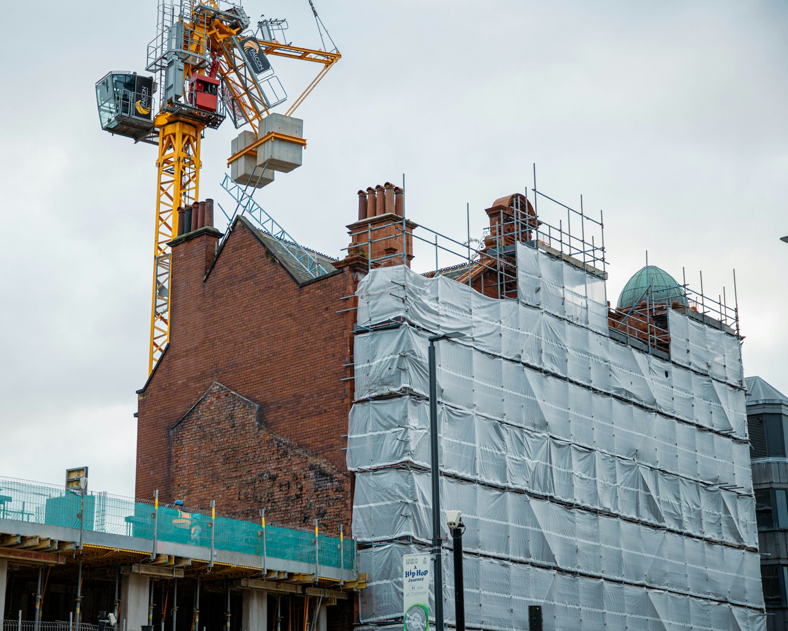 A tower crane over a scaffolded building site
