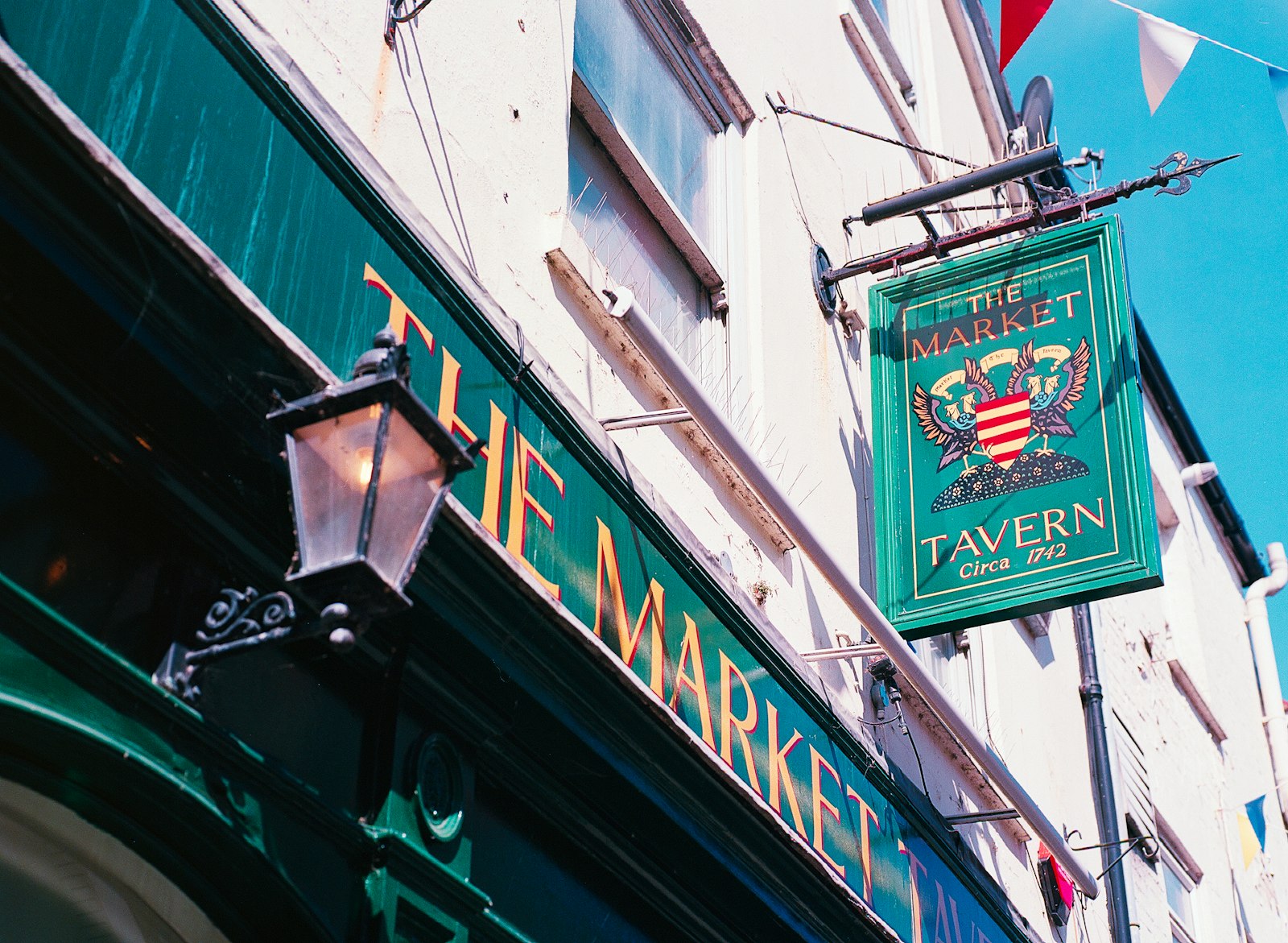 A painted pub sign for The Market Tavern